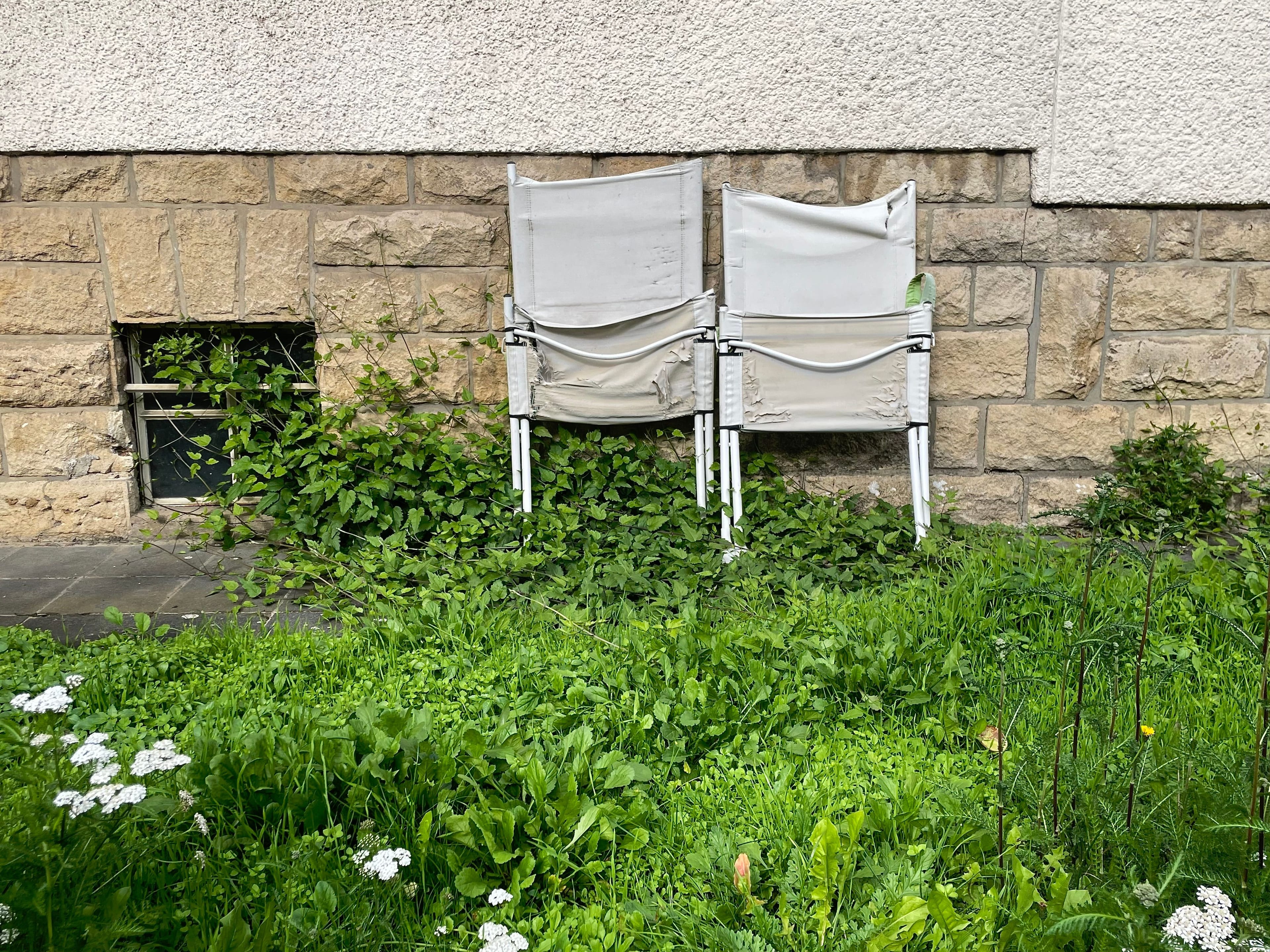 White chairs leaning on a wall, Luxembourg.